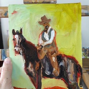 May include: Oil painting of a cowboy riding a horse. The cowboy wears a brown hat, vest, and shirt. The horse is brown and black. The background is yellow and green.