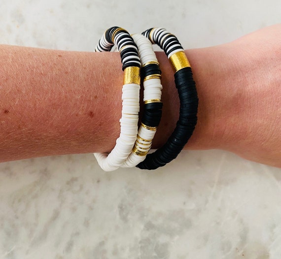 Black polymer stretch bracelet with gold cylinder bead