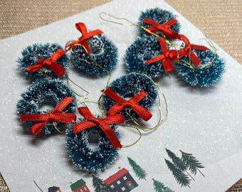 8 miniature snow dusted Christmas wreaths with red bow and gold hanger