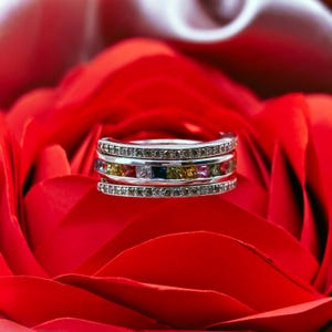 May include: A white ceramic mug with a black handle and the text "But First, Coffee" in a black, bold font. The mug is on a white surface.