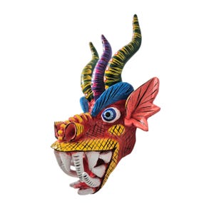 May include: A hand-painted, colorful dragon mask. The mask features a red face with yellow and white teeth, blue eyes, and a blue and red ear. The horns are green, purple, and yellow. This decorative mask is a unique piece of art.