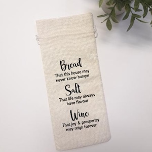 May include: A handcrafted wooden sign, painted white with black lettering, reading "Welcome to our home". The sign has a distressed finish, suitable for indoor or outdoor use. The text is in a handwritten style.