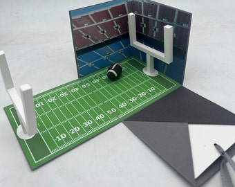 Estadio de fútbol con forma de caja explosiva, como embalaje original para cromos de fútbol, vales para partidos de fútbol y envoltorios personalizados para dinero.