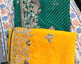 May include: Three silk scarves with embroidered designs. The top scarf is pink with a floral pattern, the middle scarf is green with a peacock design, and the bottom scarf is yellow with a floral design.