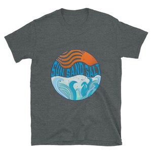 May include: A dark gray t-shirt with a circular graphic design. The graphic features a stylized orange sun with waves and the text "SUN SAND SALT" in blue.