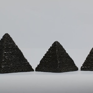 The three Ancient Egyptian pyramids - The Pyramid of Khafre and the Great Pyramid of Khufu and Menkaure&#39;s pyramid - made from Black stone
