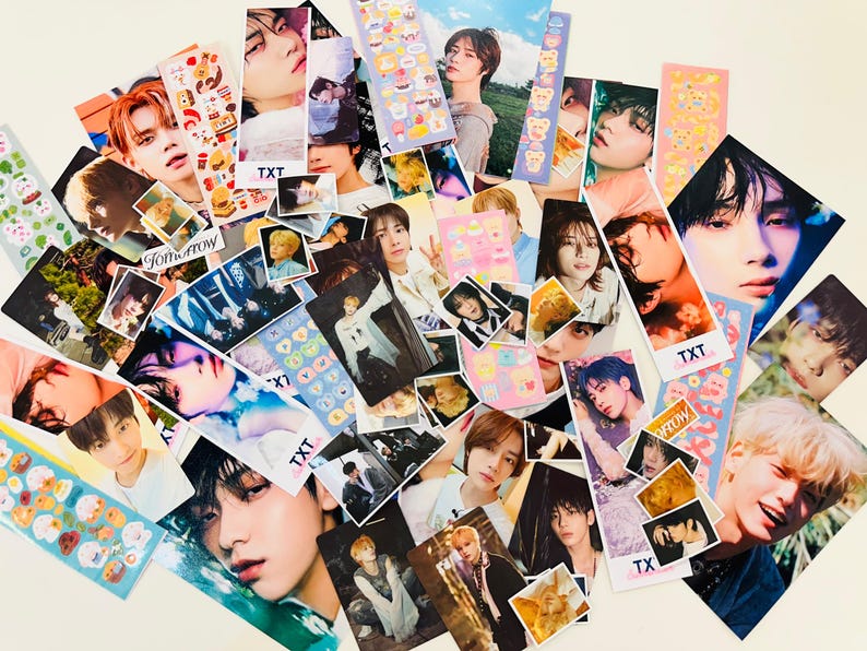 May include: A collection of colorful photo cards featuring various K-pop idols. The cards feature images of the idols in different poses and outfits, with some cards also including text such as "TXT" and "Tomorrow X Together".