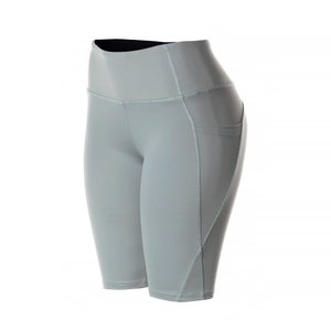 May include: Gray athletic shorts with a high waist and a pocket on the right side.