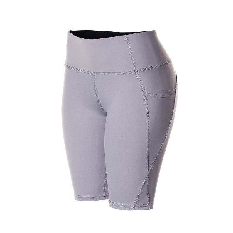 May include: Gray athletic shorts with a high waist and a pocket on the right side.