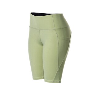 May include: Light green athletic shorts with a high waist and a pocket on the right side.