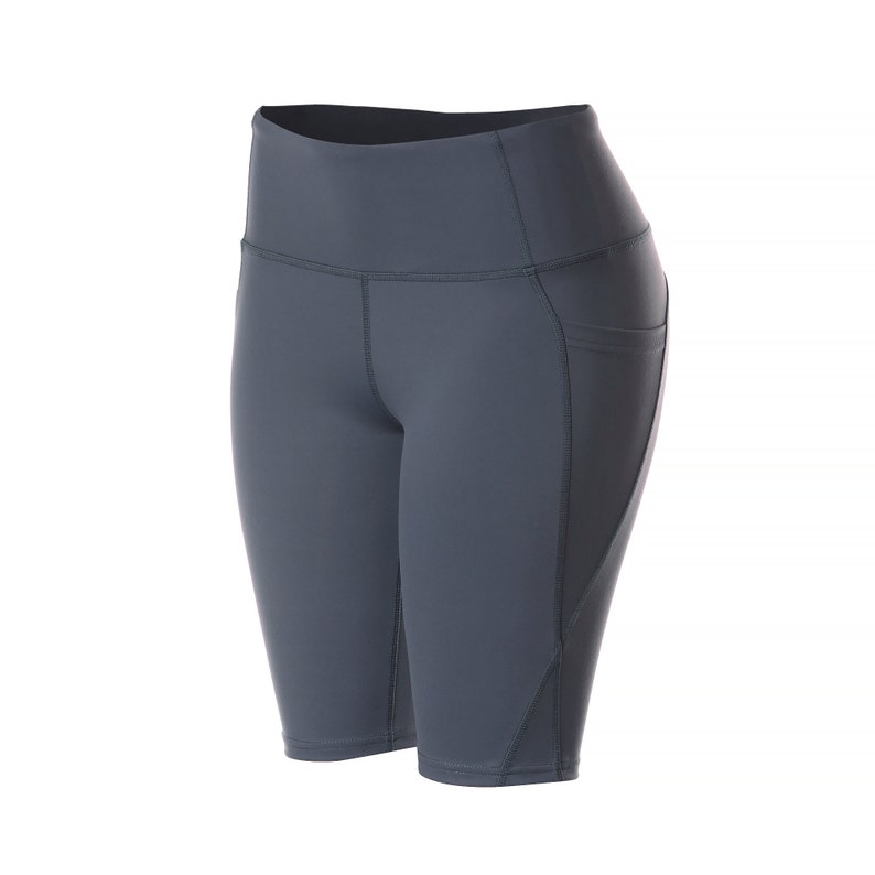 May include: Gray athletic shorts with a high waist and a pocket on the right side.