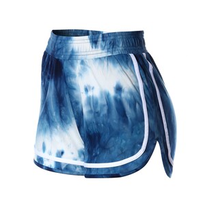May include: Blue and white tie-dye shorts with white trim along the sides. The shorts have an elastic waistband.