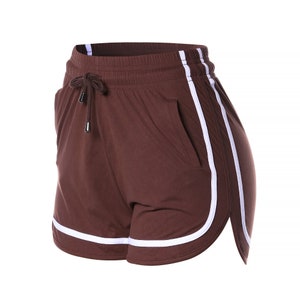 May include: Brown athletic shorts with white side stripes and a drawstring waist.