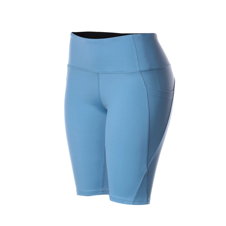 May include: Light blue athletic shorts with a high waist and a black waistband. The shorts have a pocket on the right side.