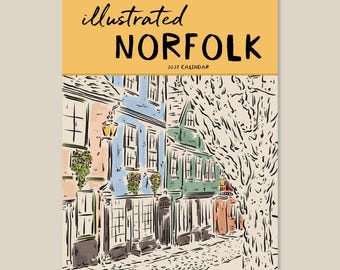 May include: A 2027 wall calendar titled Illustrated Norfolk. The cover features a yellow header with black text and a detailed ink and watercolour illustration of a cobblestone street lined with colourful buildings and a large tree.