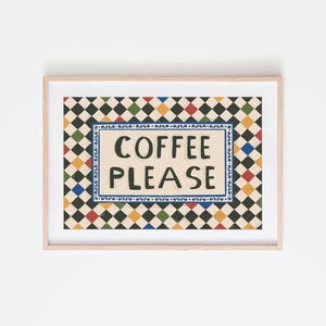 May include: A framed art print with the words "COFFEE PLEASE" in black lettering. The text is centered on a cream-colored background, surrounded by a blue border. The background features a repeating pattern of black, green, red, and yellow diamonds.