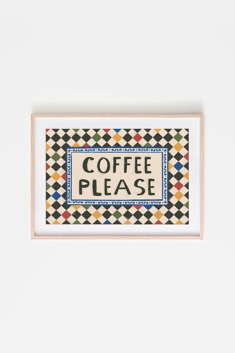 May include: A framed art print with the words "COFFEE PLEASE" in black lettering. The text is centered on a cream-colored background, surrounded by a blue border. The background features a repeating pattern of black, green, red, and yellow diamonds.