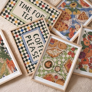 May include: A collection of framed art prints with a vintage aesthetic. The prints feature food illustrations, checkered patterns, and text that reads "Time for Tea" and "Coffee Please." The color palette includes beige, green, red, and blue.