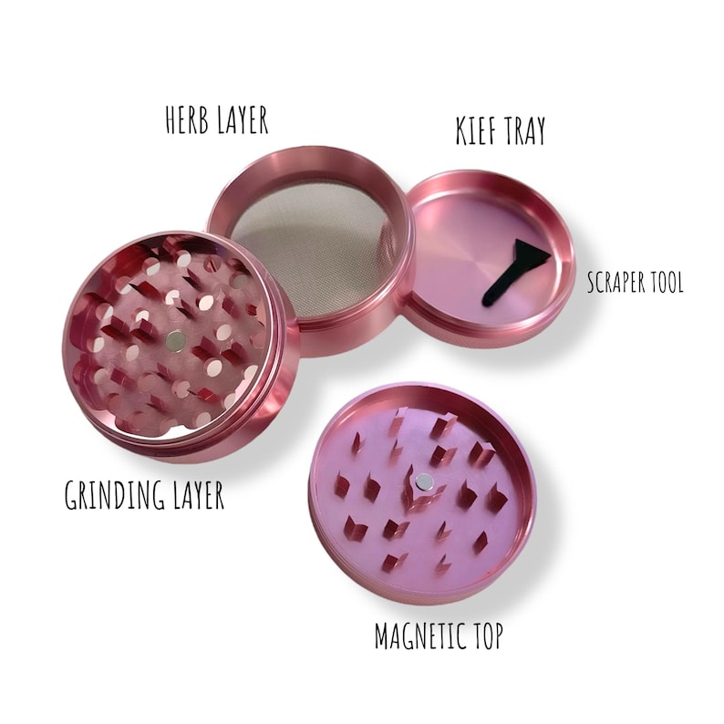 May include: A pink metal grinder with four parts: a grinding layer, a herb layer with a screen, a kief tray, and a magnetic top. The kief tray has a scraper tool.