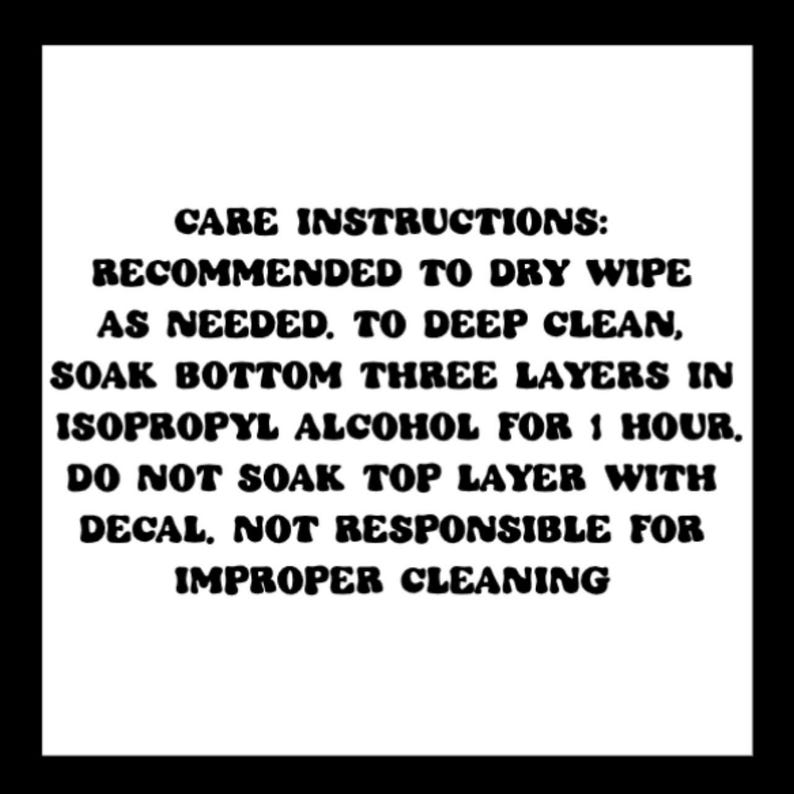 May include: White background with black text detailing care instructions. The text recommends dry wiping as needed, soaking the bottom three layers in isopropyl alcohol for one hour for deep cleaning, and avoiding the top layer with the decal.