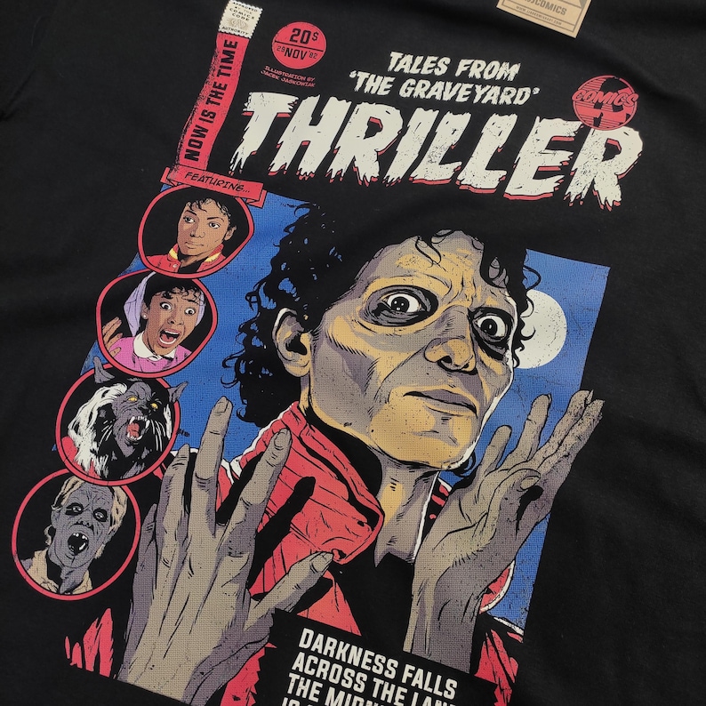 May include: A black t-shirt with a comic book cover design featuring a zombie Michael Jackson from the "Thriller" music video. The cover reads "Tales from 'The Graveyard'" and "Thriller" with a comic book logo.