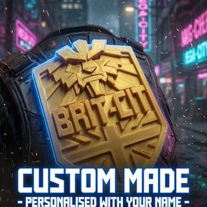May include: A gold-colored 3D printed badge featuring a stylized lion head above the text BRIT-CIT and a Union Jack design. The badge is mounted on a dark textured surface. Text below reads CUSTOM MADE - PERSONALISED WITH YOUR NAME - HIGH QUALITY 3D PRINT.