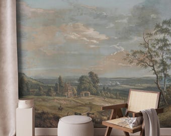 Puede incluir: Un mural de papel tapiz de estilo vintage que representa un paisaje campestre con un edificio de piedra, árboles y un cielo nublado. El mural se muestra en una habitación con una silla de madera y un puf blanco.
