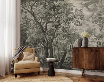May include: A black and white vintage illustration of a forest scene with trees and a cloudy sky. The illustration is printed on a wallpaper mural and is displayed in a living room setting with a chair, side table, and a wooden cabinet.