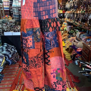 May include: Patchwork pants with a colorful, multi-patterned design. The pants are made of a soft, flowing fabric and have a wide, comfortable waistband.