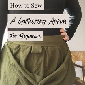 May include: How to Sew A Gathering Apron For Beginners. A green apron with a gathered waist is shown on a person wearing a black shirt.
