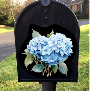 May include: A black mailbox with a blue hydrangea flower decal. The mailbox is mounted on a metal post.