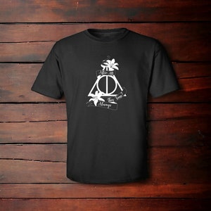 May include: Black t-shirt featuring a white graphic of the Deathly Hallows symbol from the Harry Potter series. The symbol is surrounded by lilies and a banner that reads "After all this time? Always."