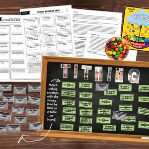 May include: A wooden-framed chalkboard with the word "TITHING" in large letters. The board has money-themed envelopes and text. Additional papers and a colorful candy-filled container are also present, along with a card that says "Tithing opens the windows of heaven".