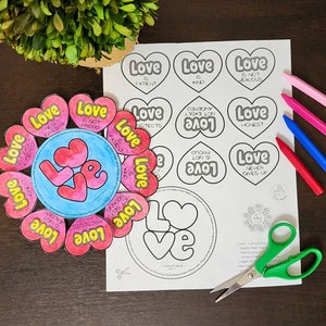 May include: A printable Valentine's Day craft for kids featuring a heart-shaped flower with the word "Love" in the center and different qualities of love written on each petal. The printable also includes a circle with the word "Love" and a smaller circle with the text "1 Corinthians 13:4-7".
