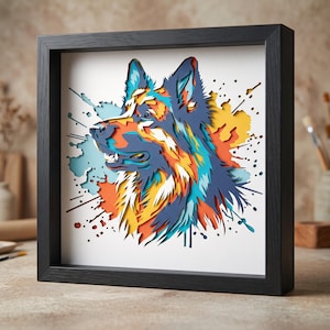 May include: A multi-layered paper cut art piece featuring a German Shepherd profile in a black square frame. The dog is rendered in vibrant shades of blue, orange, yellow, and white with a dynamic paint splatter background effect on a white base.