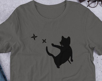 May include: A dark gray t-shirt with a black silhouette of a cat throwing three black ninja stars.
