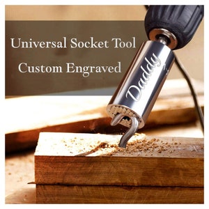 May include: A silver universal socket tool with a drill attachment. The tool is engraved with the word "Daddy".