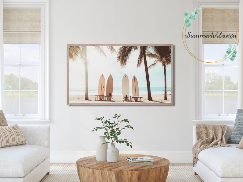May include: A framed print of four surfboards leaning against each other on a beach with palm trees in the background.