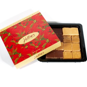 May include: A red and gold box with a poinsettia design and the text "Hall's Candies" on the lid. The box is open and reveals a tray of fudge squares in two colors: brown and tan. The tray is black and has a white background.