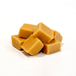 May include: A close-up of a pile of golden brown fudge squares.