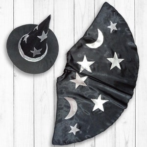 May include: Black witch costume with a pointed hat and a cape decorated with silver stars and crescent moons.