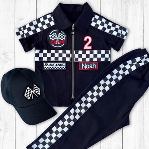 May include: Black and white checkered racing outfit for a child. The outfit includes a jacket with a zipper, a pair of pants, and a black baseball cap with a checkered flag design. The jacket has patches that say "Speed", "Racing", and "Noah". The pants have a checkered stripe down the side.