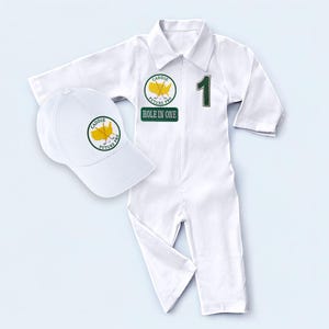 A close-up shot focusing on the upper body of the long-sleeve white golf coverall. It reveals the fabric's soft texture, the button-down collar design, and the precision of the "Hole in One" and custom name patches. This detailed image helps customers see the stitch quality and the premium feel of the handmade garment.