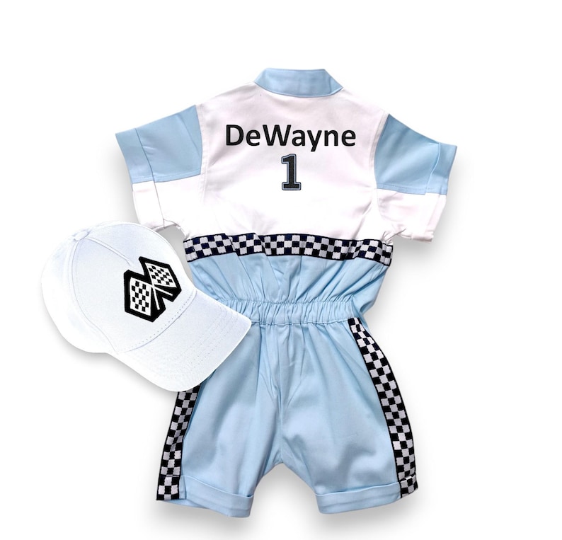 May include: A white and light blue racing jumpsuit with a black checkered trim. The jumpsuit has the name "DeWayne" and the number "1" on the back. A white baseball cap with a black checkered flag design is included.