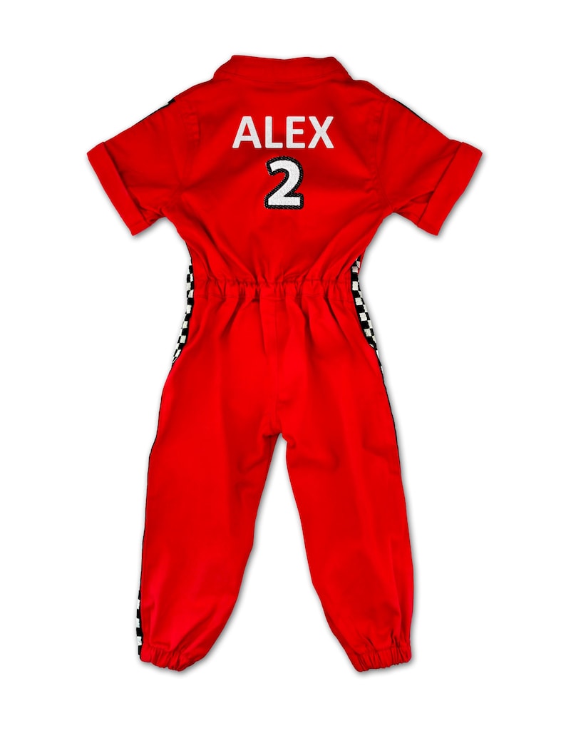Kids racing suit costume set – vibrant red jumpsuit with black-white checkered stripes, race car details, and elastic ankle design. Includes red racing cap. Personalized with name and number on the back. Ideal for themed birthdays, costumes, and role play.