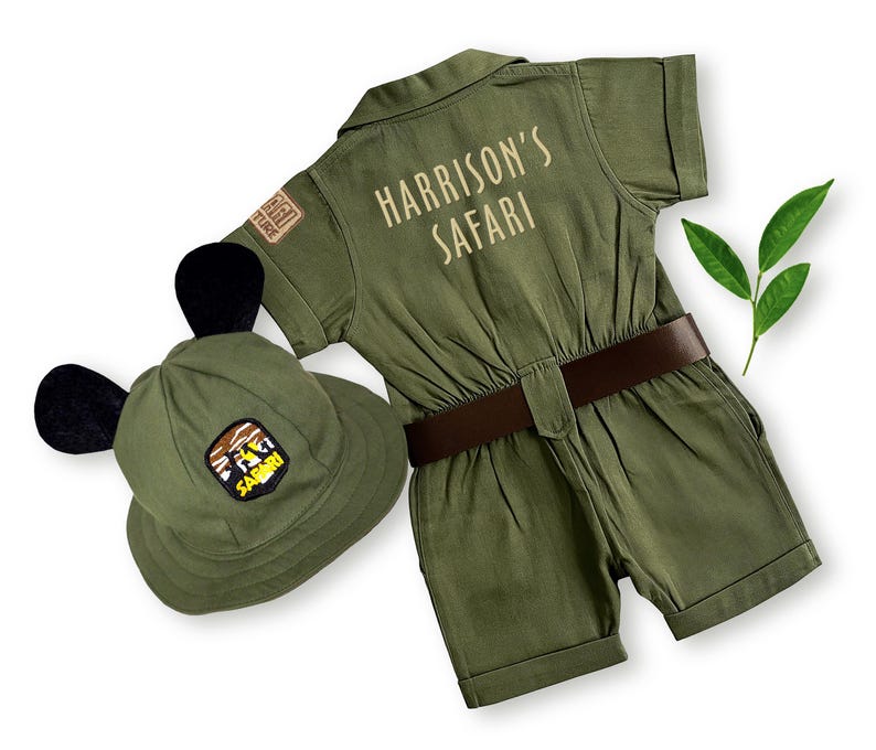 Detailed rear view of the safari explorer jumpsuit with "Harrison's Safari" custom name embroidery paired with a hat featuring black ears. Ideal for Two Wild birthday parties, this handmade costume offers a unique and playful look for toddlers.