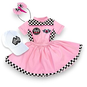 May include: A pink and white checkered racing-themed dress with a white cap and a pink headband. The dress has a black and white checkered trim and a white collar. The cap has a black and white checkered flag design. The headband has a pink bow.