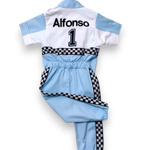 May include: A light blue jumpsuit with black and white checkered trim. The back of the jumpsuit has the name "Alfonso" and the number "1" in black.
