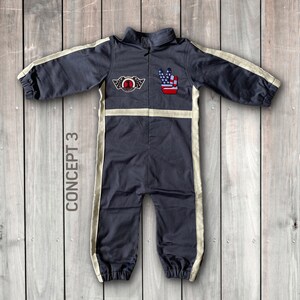 May include: A dark gray jumpsuit with white stripes down the sides. The jumpsuit has a patch on the chest with a number one and wings, and a peace sign patch with an American flag design on the right shoulder. The text "CONCEPT 3" is written vertically on the left side of the image.