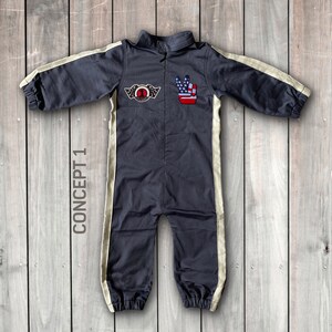 May include: A dark gray jumpsuit with white stripes down the sides. The jumpsuit has a zipper in the front and a patch on the chest with a number one and wings. There is also a patch on the right side of the chest with a peace sign and an American flag.